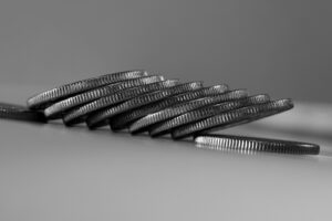 a stack of silver coins sitting on top of a table