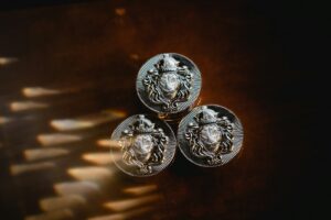 a close up of three Silver IRA metal knobs on a table